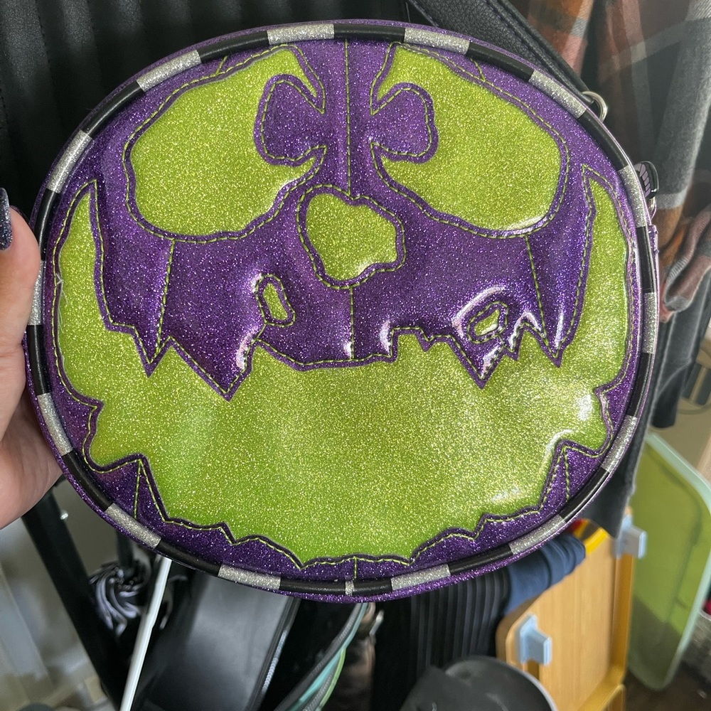 Love pain and stitches trick or trash purse sparkle purple and green.